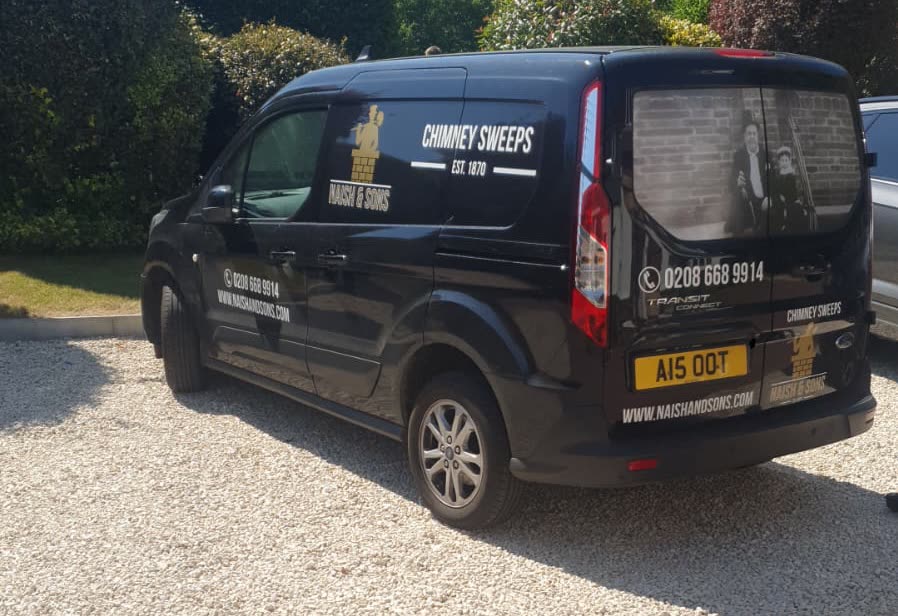 The rear of the Naish & Sons van with the historic family photograph in the back window